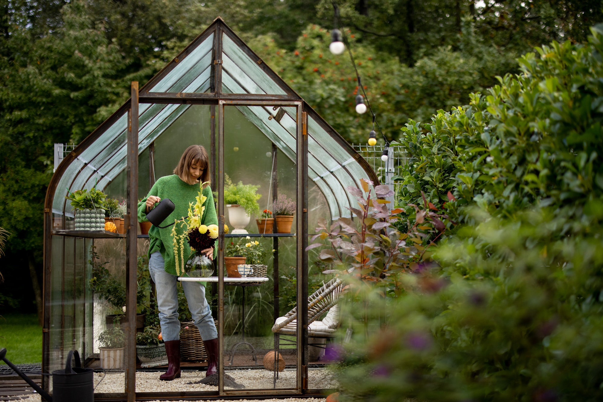 Woman with flowers in greenhouse